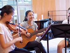 Photo of students playing instruments. 